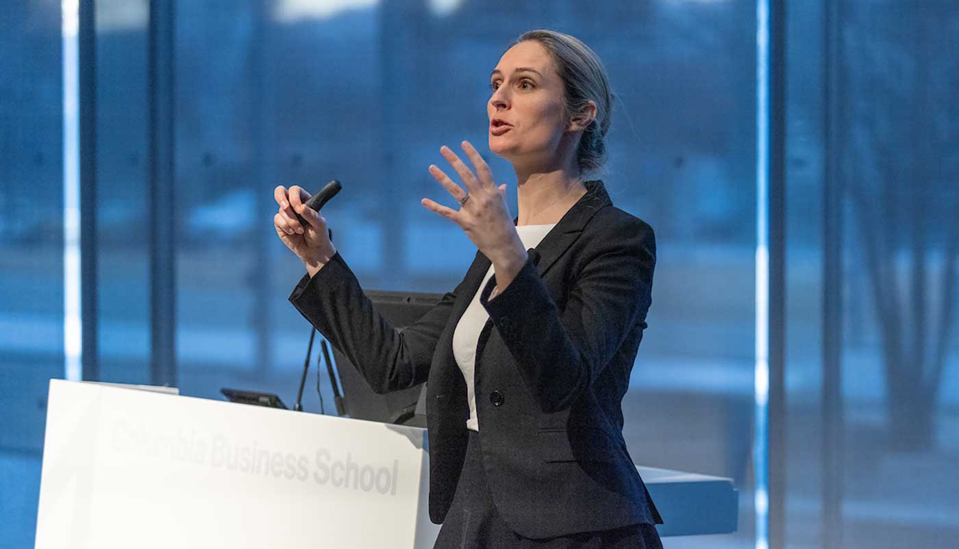 A female presenter addressing the audience at the AI Summit Satellite Session